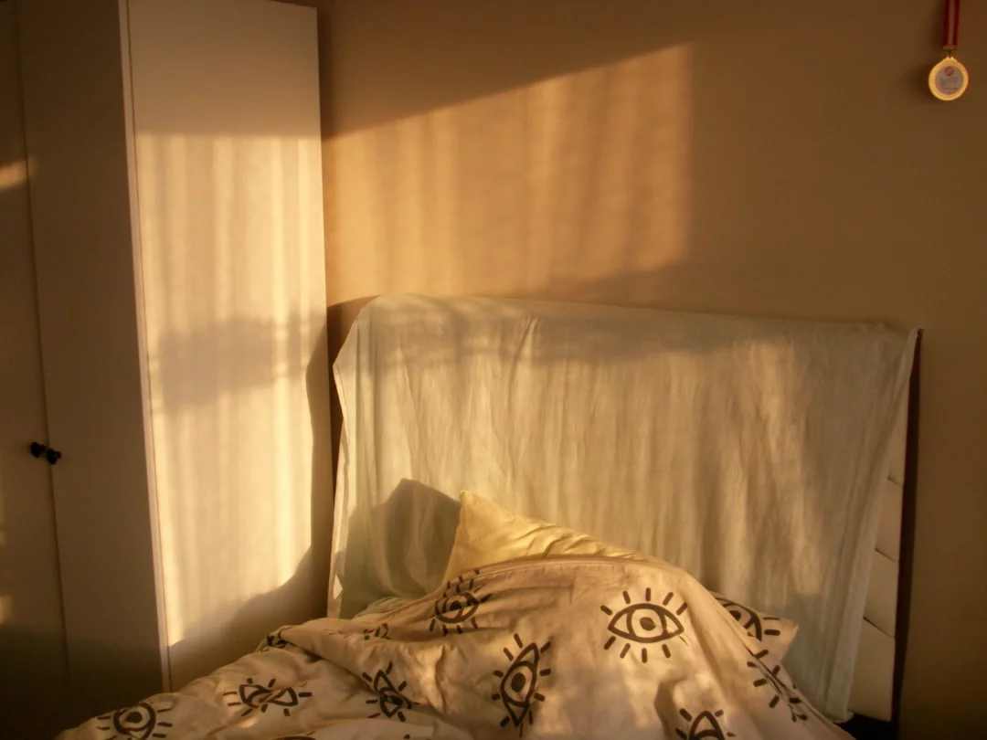 Warm morning sunlight fills a bedroom, reflecting Andrew Huberman sleep cocktail habits like light timing and sleep setup