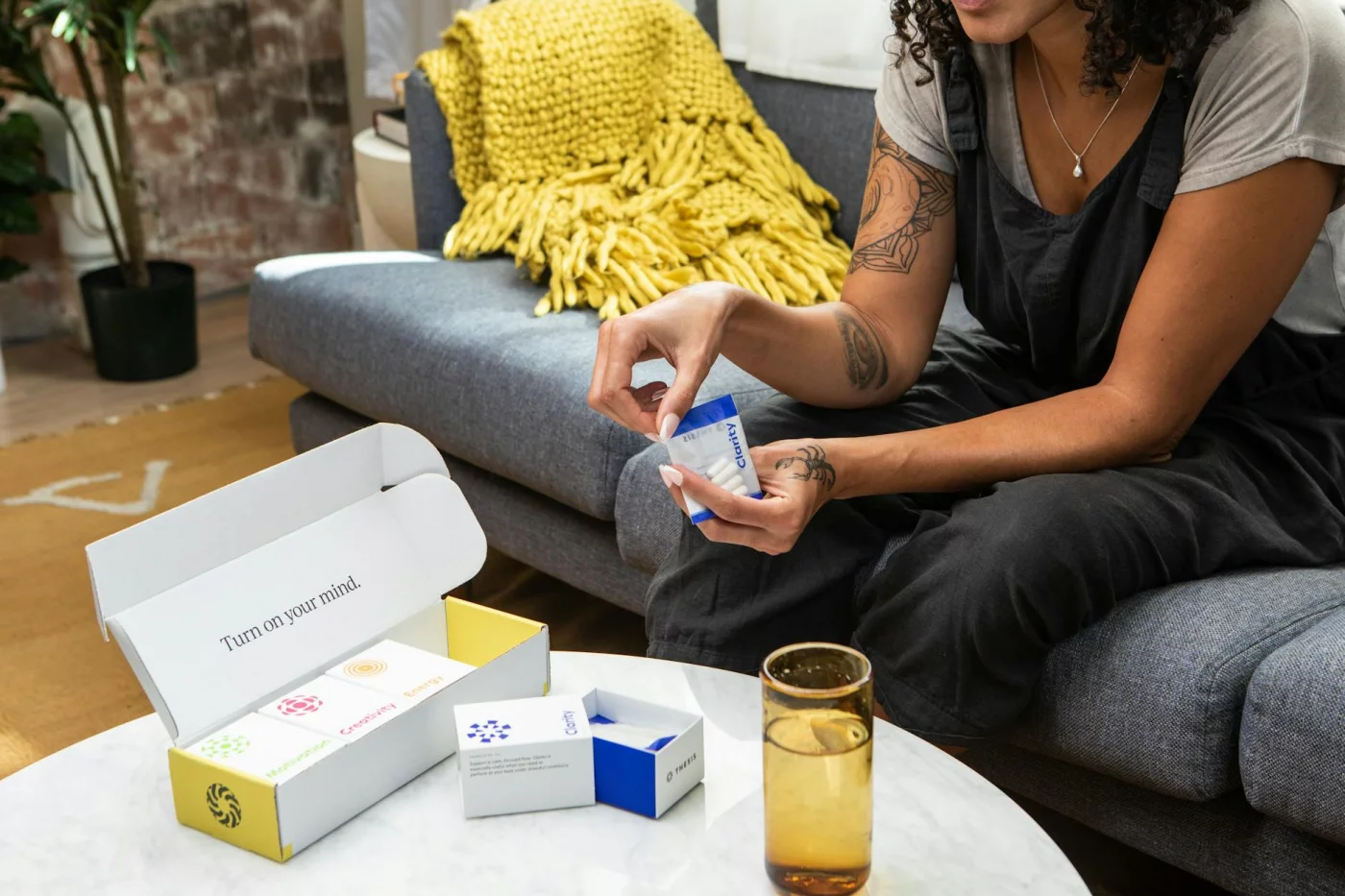 Best Brain Supplements for Adults: What Actually Has Evidence for Focus? Woman on a sofa comparing nootropics using evidence-based rules for best brain supplements for adults
