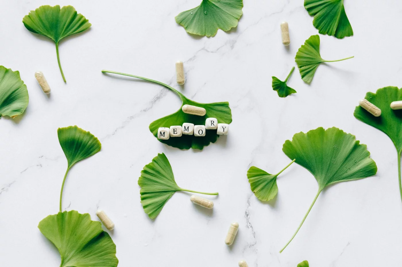 Best Brain Supplements for Adults: What Actually Has Evidence for Focus? Ginkgo leaves and memory capsules illustrating best brain supplements for adults and evidence-based focus support