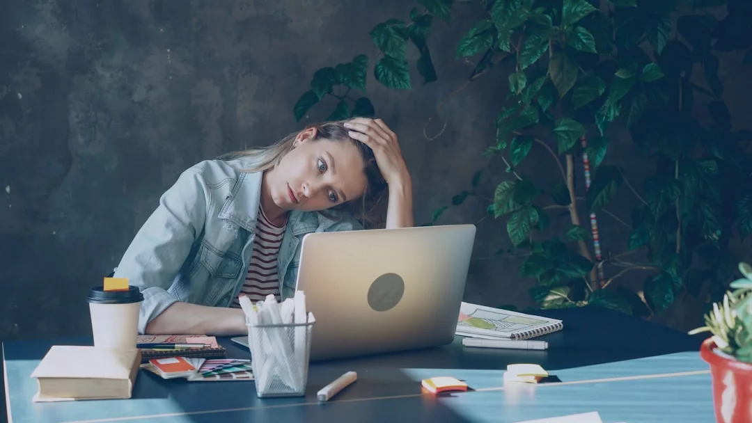 Best Supplements for High Cortisol: Evidence and Cautions Woman stressed at laptop with brain fog, exploring best supplements for high cortisol to improve focus