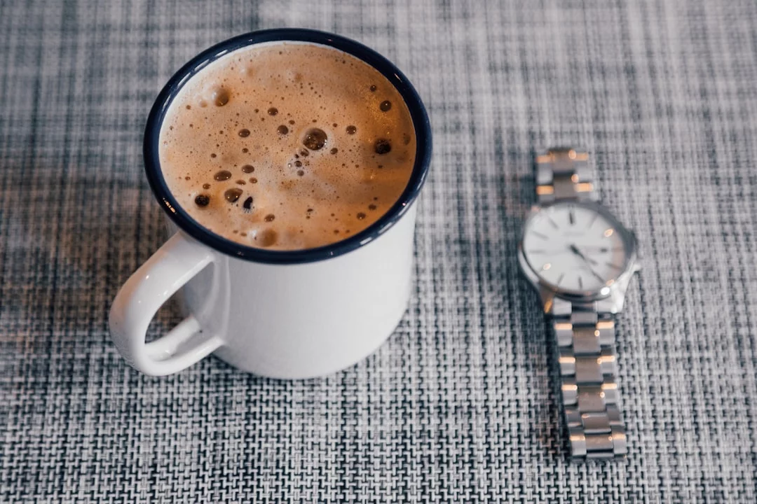 White ceramic mug of coffee illustrating the best time to drink coffee for studying by learning phase