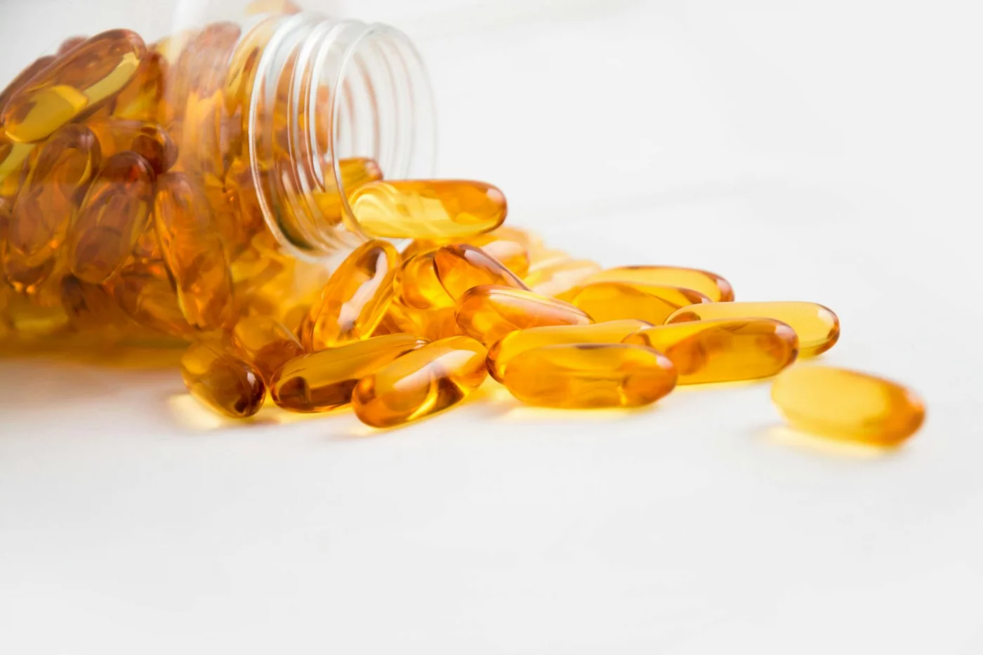 Foods for Brain Health, Memory, and Studying Fish oil capsules spilling from a bottle, brain food for studying before exams and supporting memory