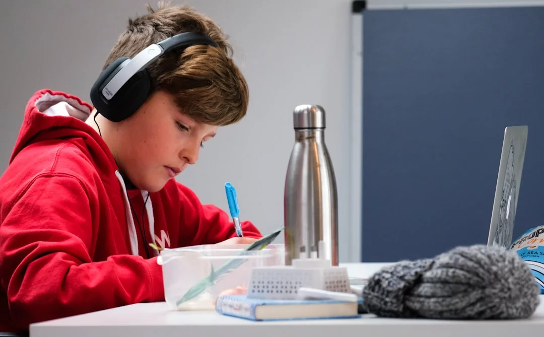 Music vs Background Noise for Studying Woman in red and white hoodie with black headphones, does music help you study or distract you, avoiding common mistakes