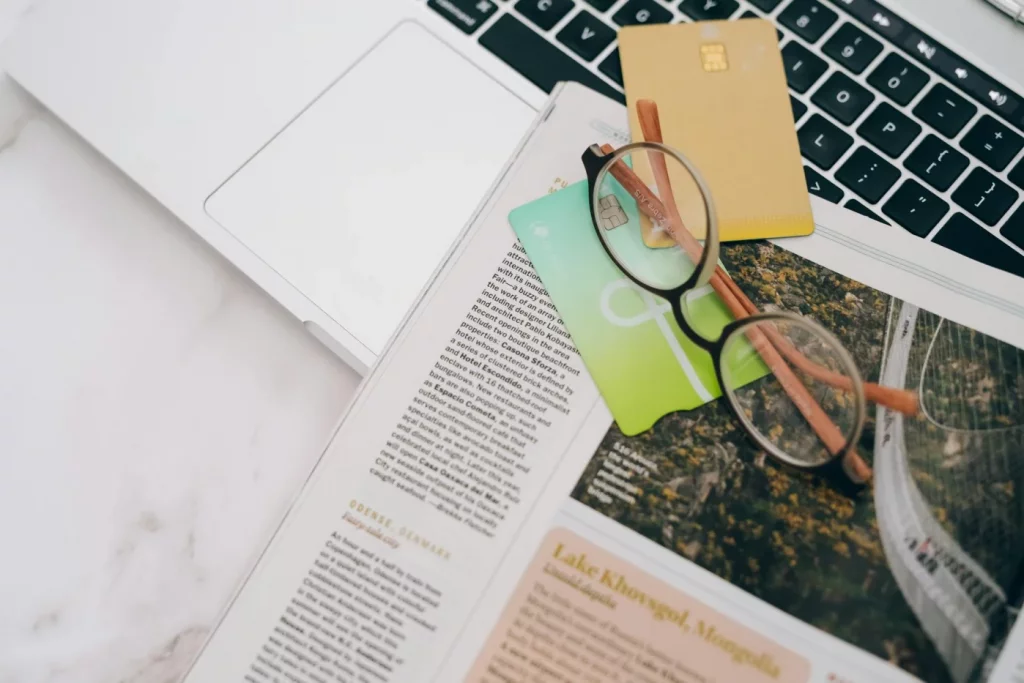 Does Speed Reading Actually Work? A Science-Based Verdict Eyeglasses on a magazine beside a laptop and cards, does speed reading work reddit discussion setup