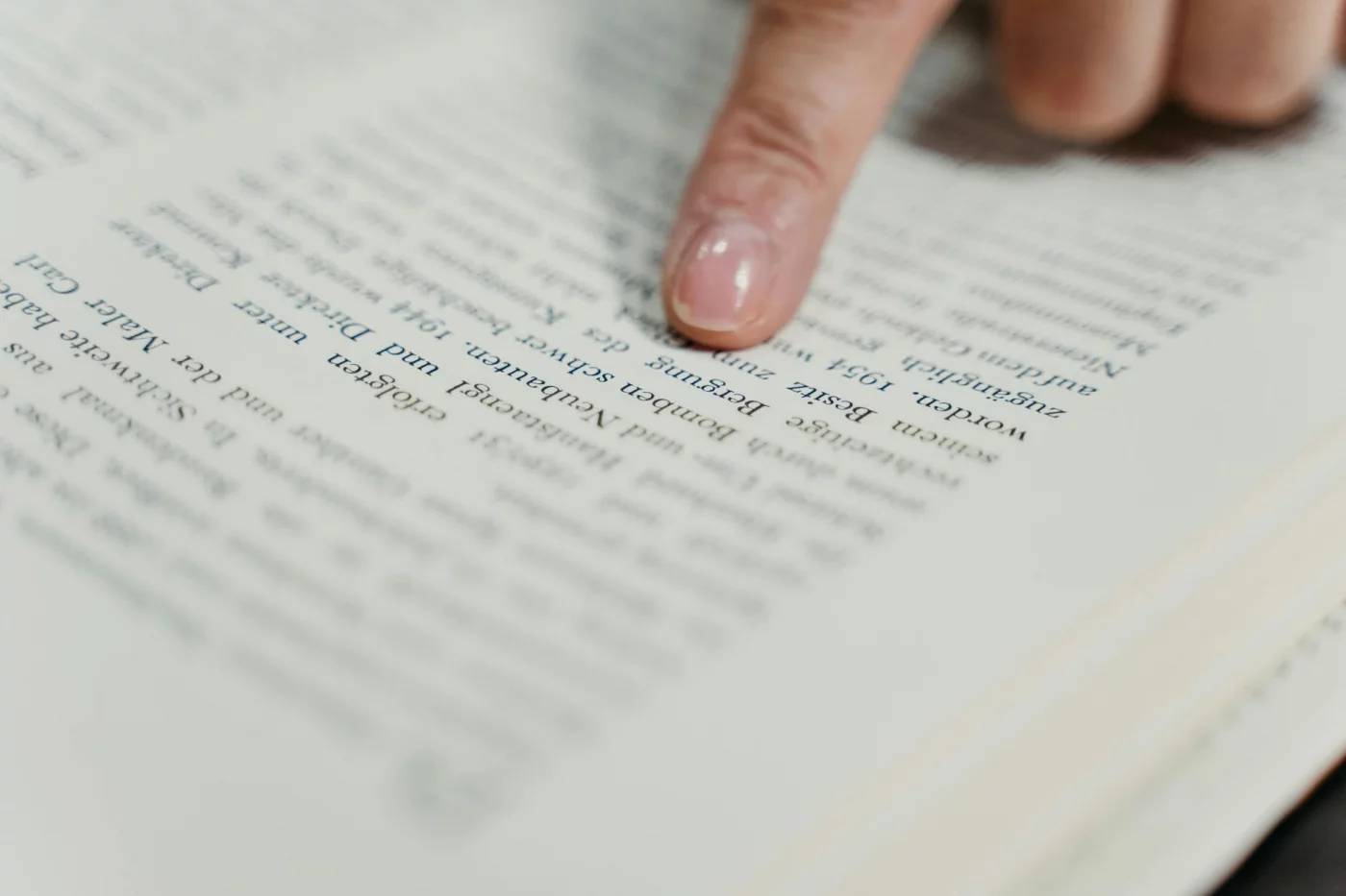Does Speed Reading Actually Work? A Science-Based Verdict Finger pointing at book text explaining how reading works and why comprehension limits speed—does speed reading work reddit