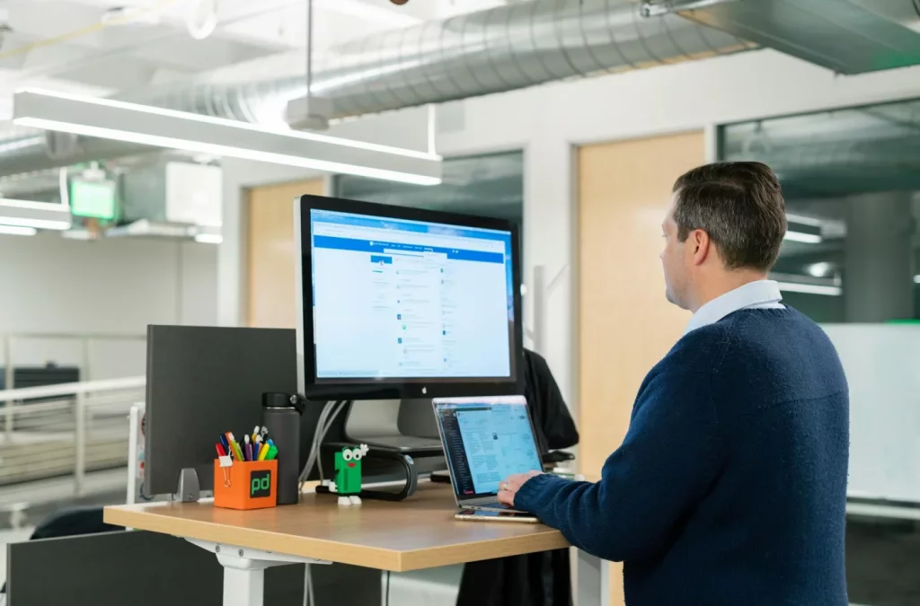 How AI Increases Productivity for Knowledge Workers Professional using LinkedIn sales tools at a standing desk, showing how does ai increase productivity at work