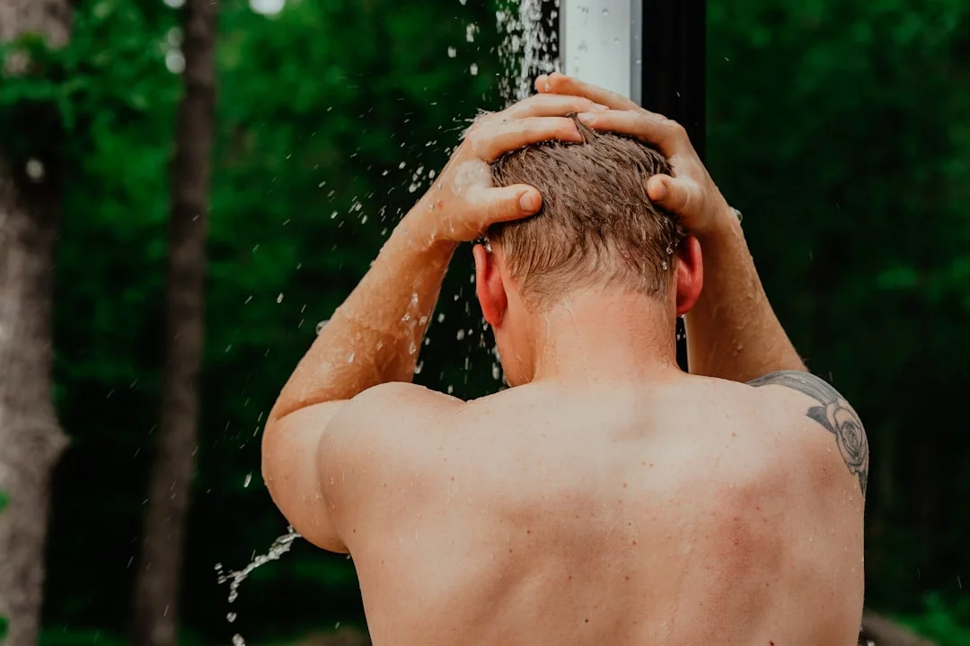 Cold Showers for Alertness and Focus: What Research Says Person with hands on head using a focus protocol to test how long should a cold shower be for alertness