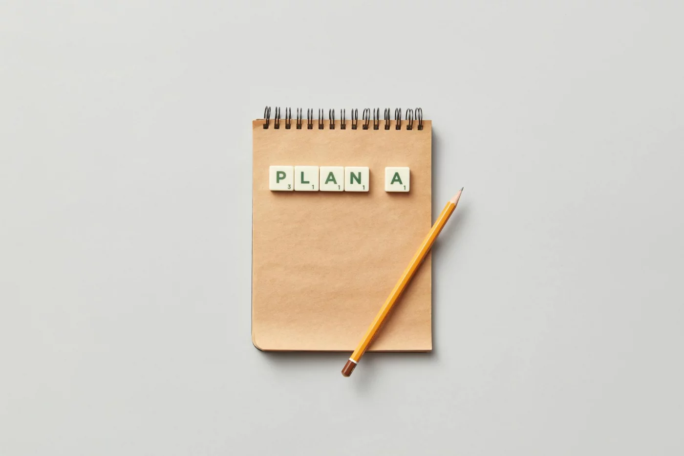 Notepad, pencil, and PLAN A tiles showing common mistakes in how to build a second brain and what to avoid