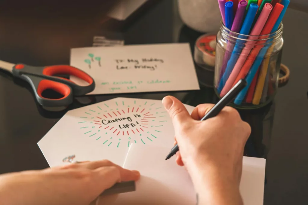 Creative workspace with markers, scissors, and a handwritten card, showing how to craft smart notes for Zettelkasten