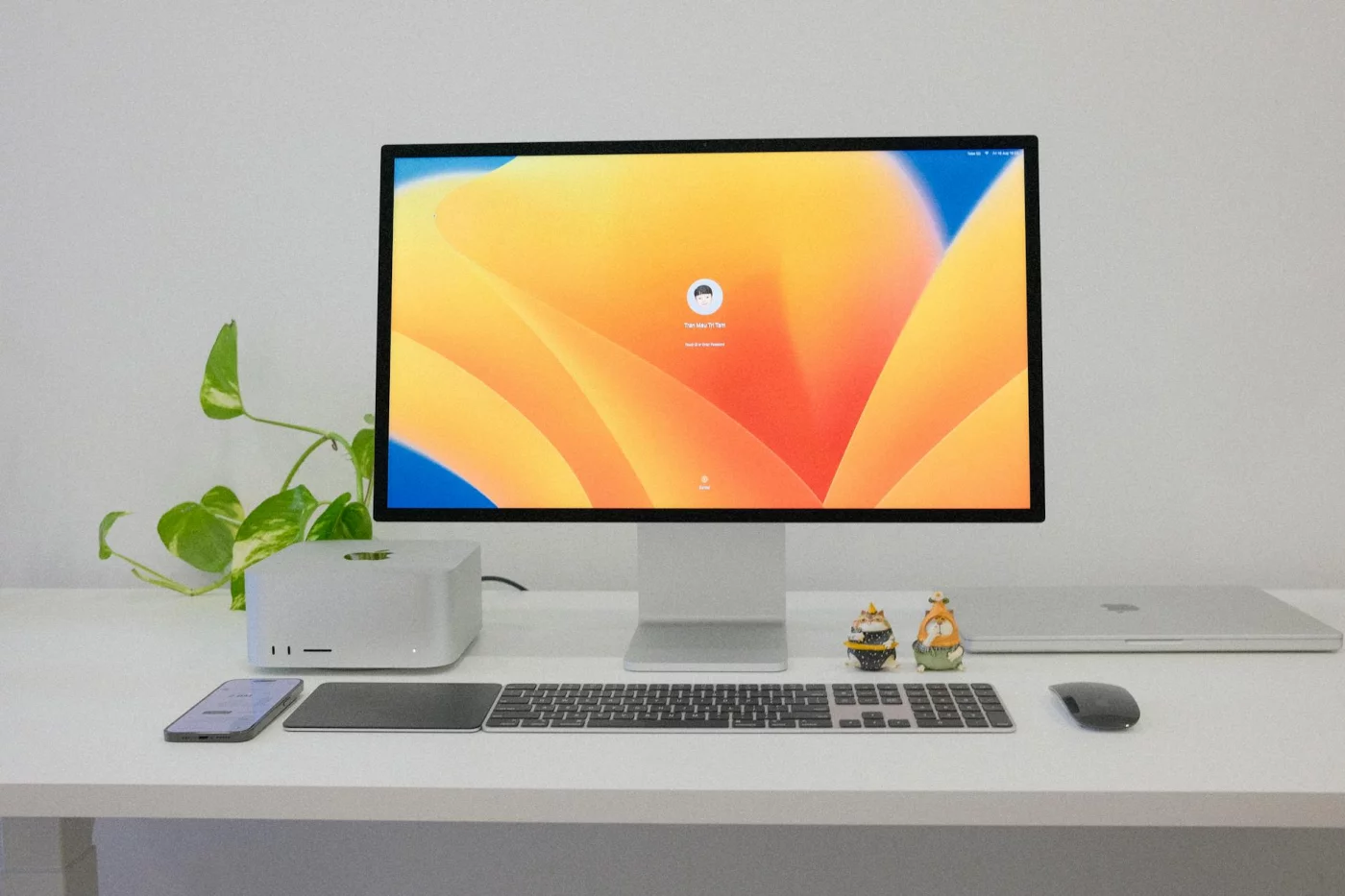 Minimalist desk setup showing how to create a focus workspace fast, with computer, keyboard, and greenery
