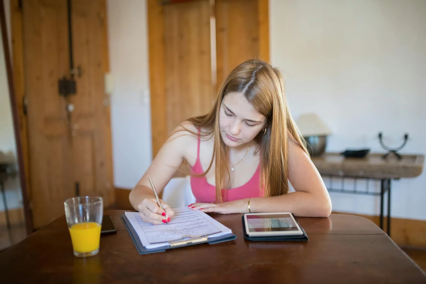 How to Learn Spanish in 6 Months: A Realistic Plan Focused student using a tablet at home, showing how to learn spanish in 6 months with a simple study system