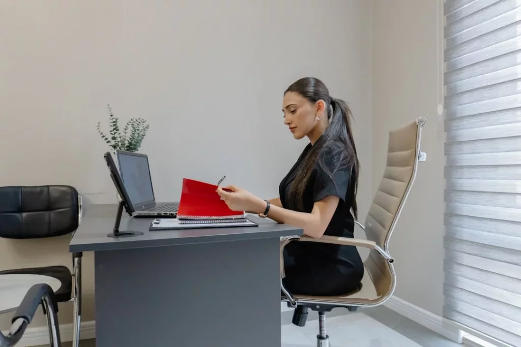 Woman working at a desk with a laptop, showing how to overcome procrastination with focused planning