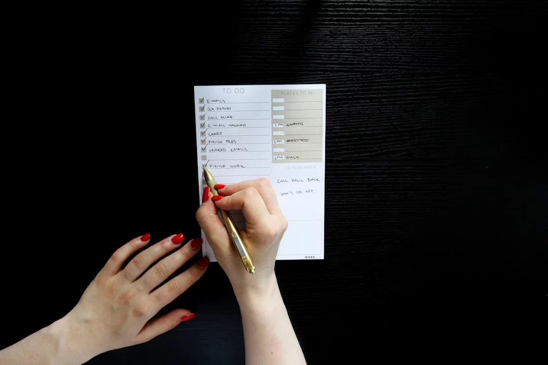 FAQ notes: how to overcome procrastination, person holding a pen writing answers on white paper