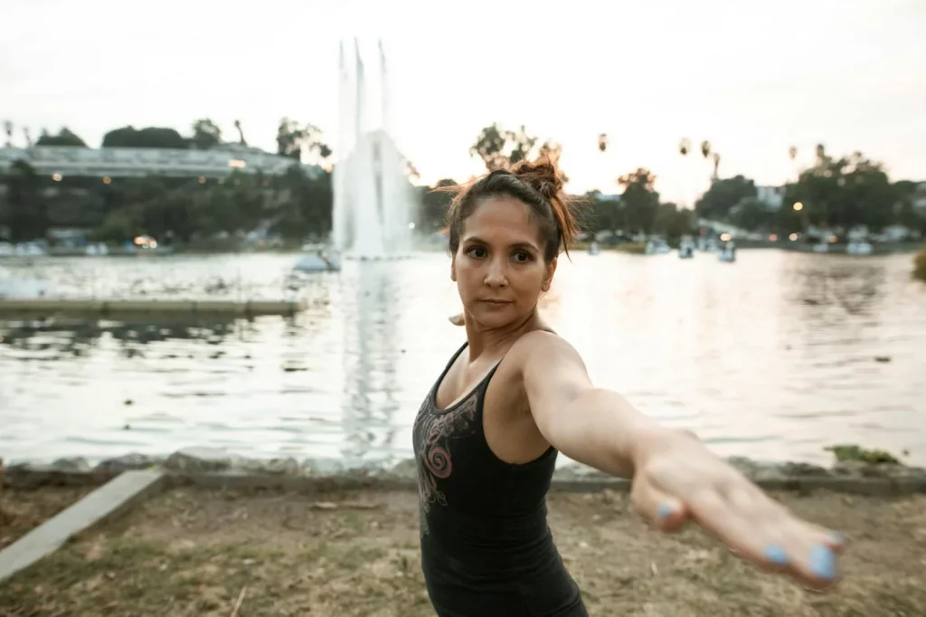 How to Reset Your Brain Without Sleeping: 7 Proven Recovery Strategies Woman practicing lakeside sunset yoga showing how to reset brain without sleeping through mindful movement