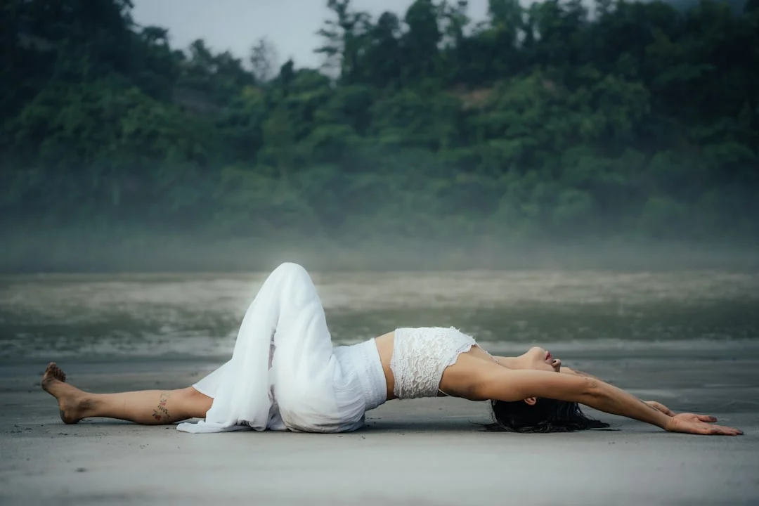 How to Reset Your Brain Without Sleeping: 7 Proven Recovery Strategies Woman lying on her back on the beach demonstrating NSDR, how to reset brain without sleeping during the day