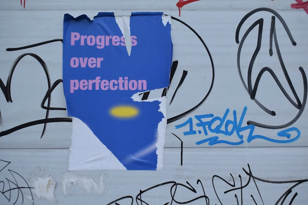 Poster urging progress over perfection shows how to stop perfectionism procrastination in work and creative projects