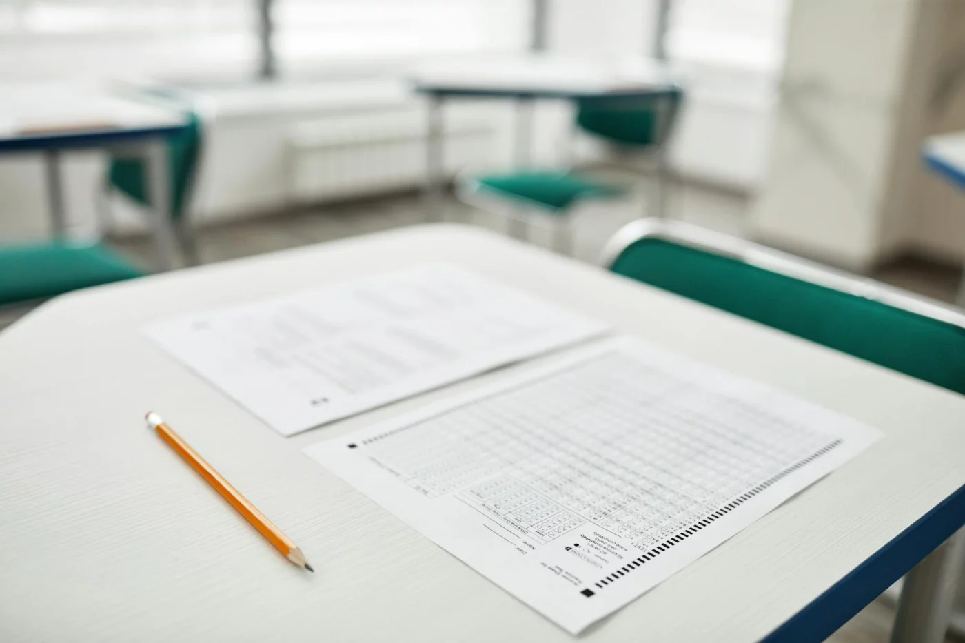 How to Study for AP Exams in the Last 30 Days Without Burning Out Exam papers and pencil on a classroom desk showing how to study for AP exams in the final 30 days