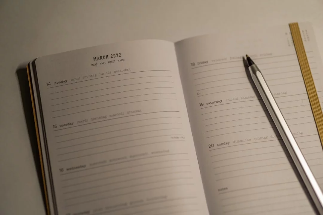 Notebook and pen beside SAT study notes showing how to study for sat in a month with a 7-step weekly plan
