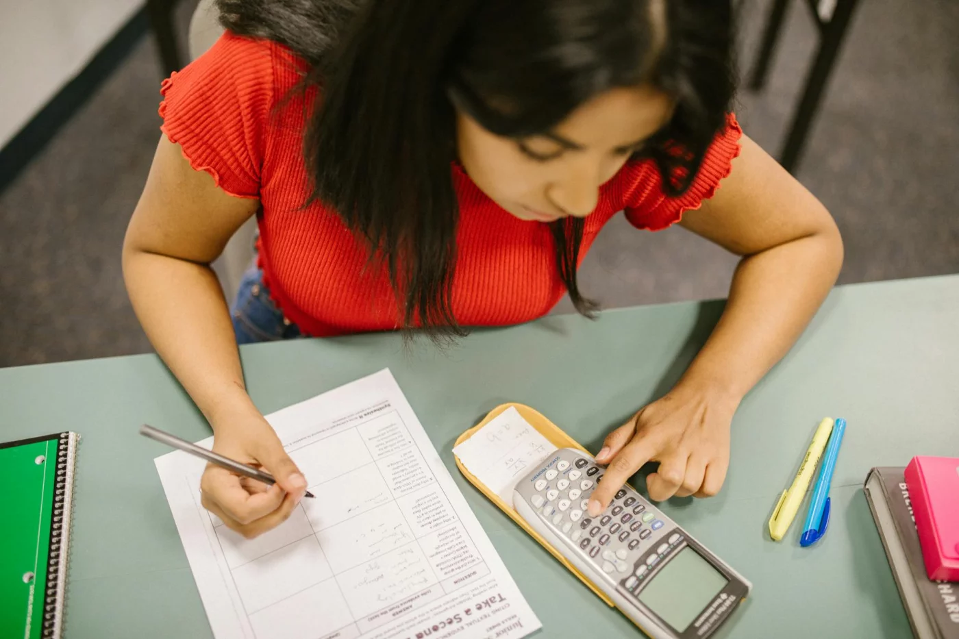 College student using a calculator on a math test for how to study for sat in a month quick-reference plans