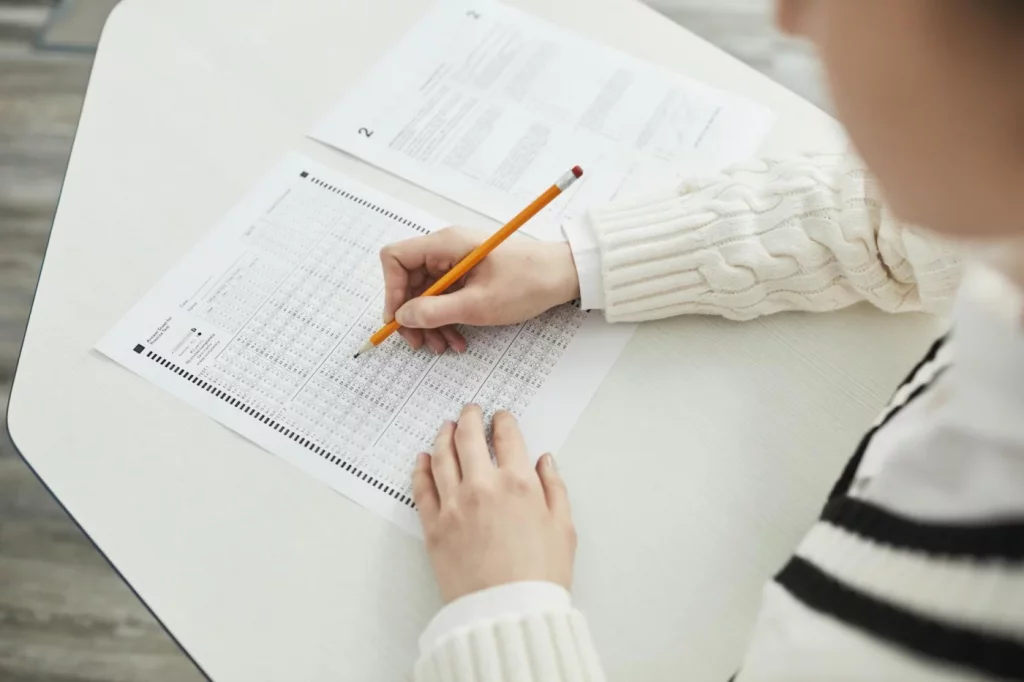 Student taking a multiple-choice practice test in class while learning how to study for the SAT effectively