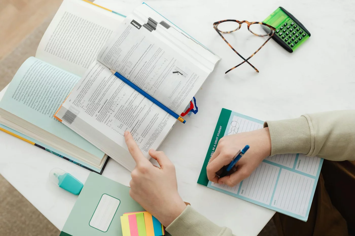 How to Study for the SAT With 8 Brain-Based Strategies That Actually Help Desk setup showing SAT study schedules, books, calculator, and notes for how to study for the SAT effectively