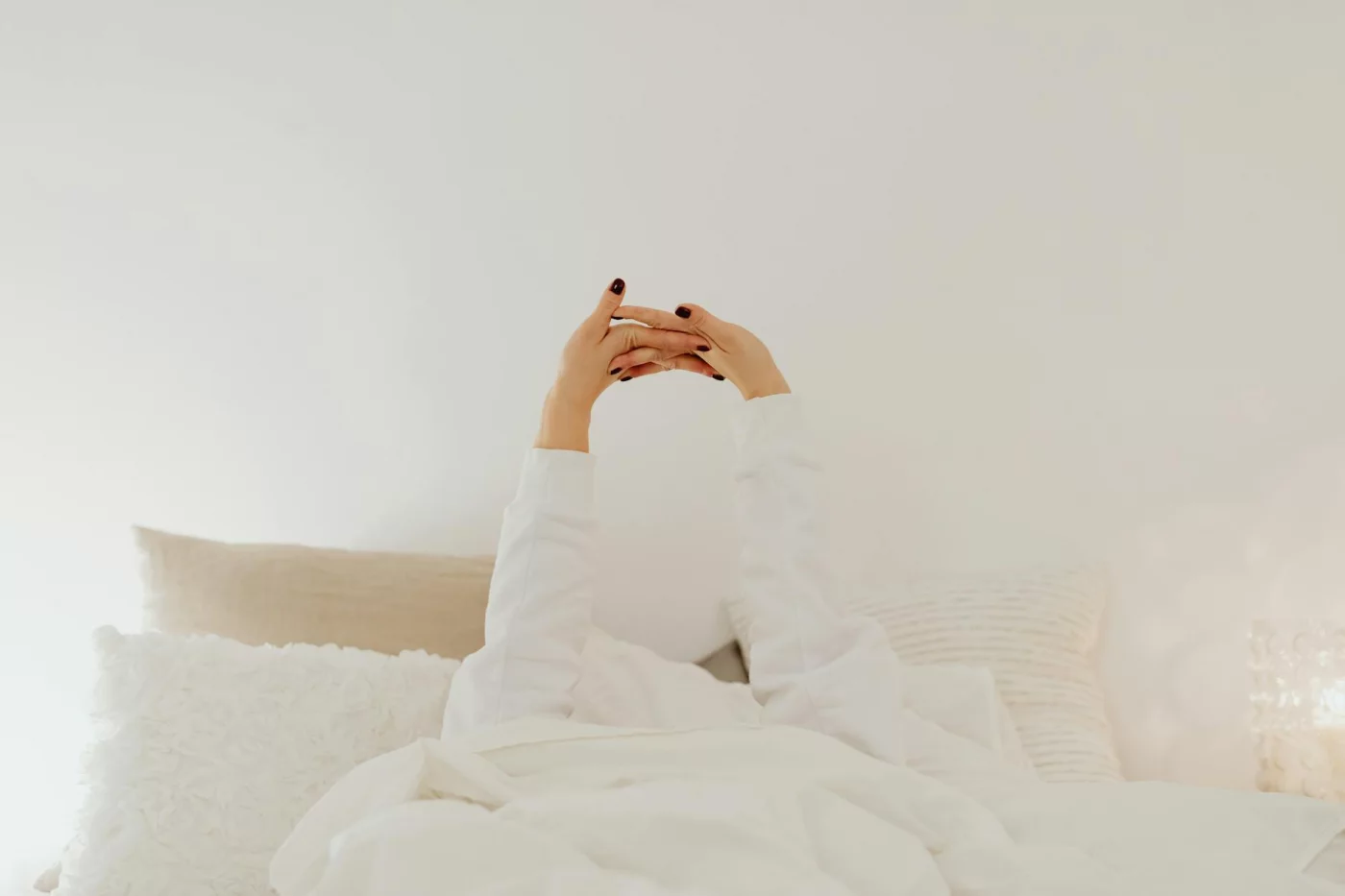 Person stretching in bed shows how to take power nap without oversleeping for better study and work focus