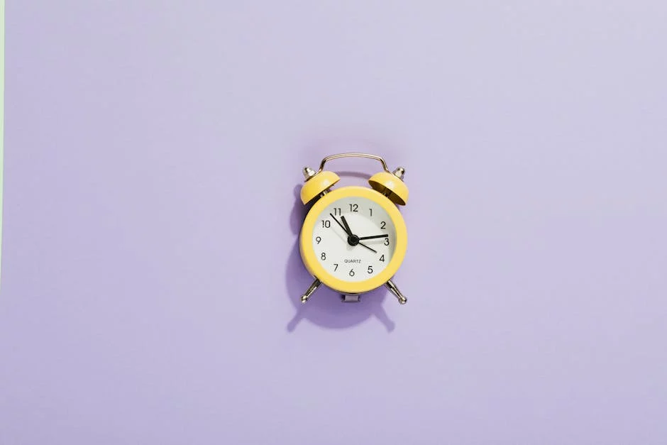 Yellow analog alarm clock on purple background illustrating how to use a meditation timer and avoid missed bells, volume issues