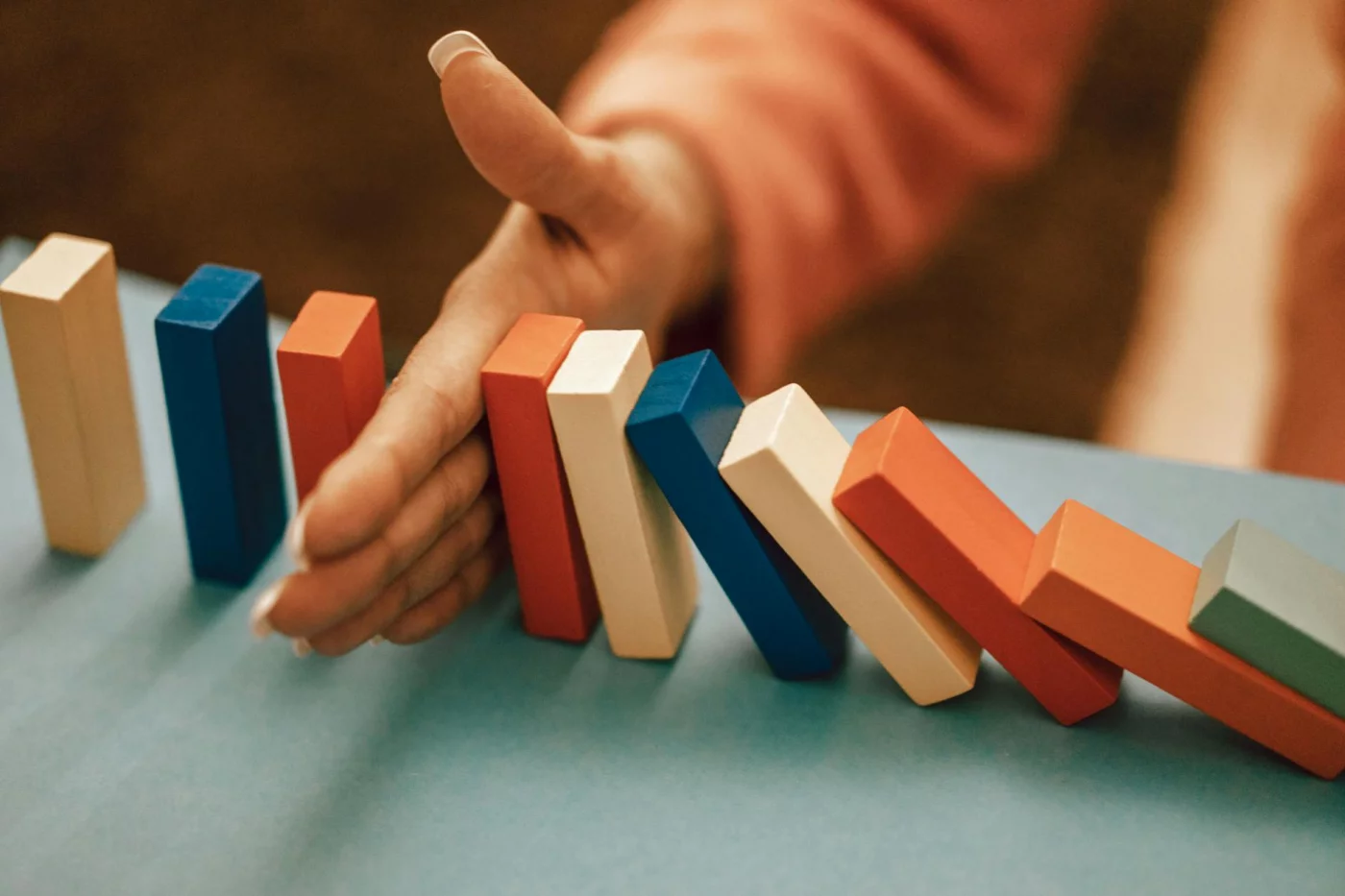 Avoid mistakes in how to use pomodoro technique for studying as a hand stops falling dominoes in a chain reaction