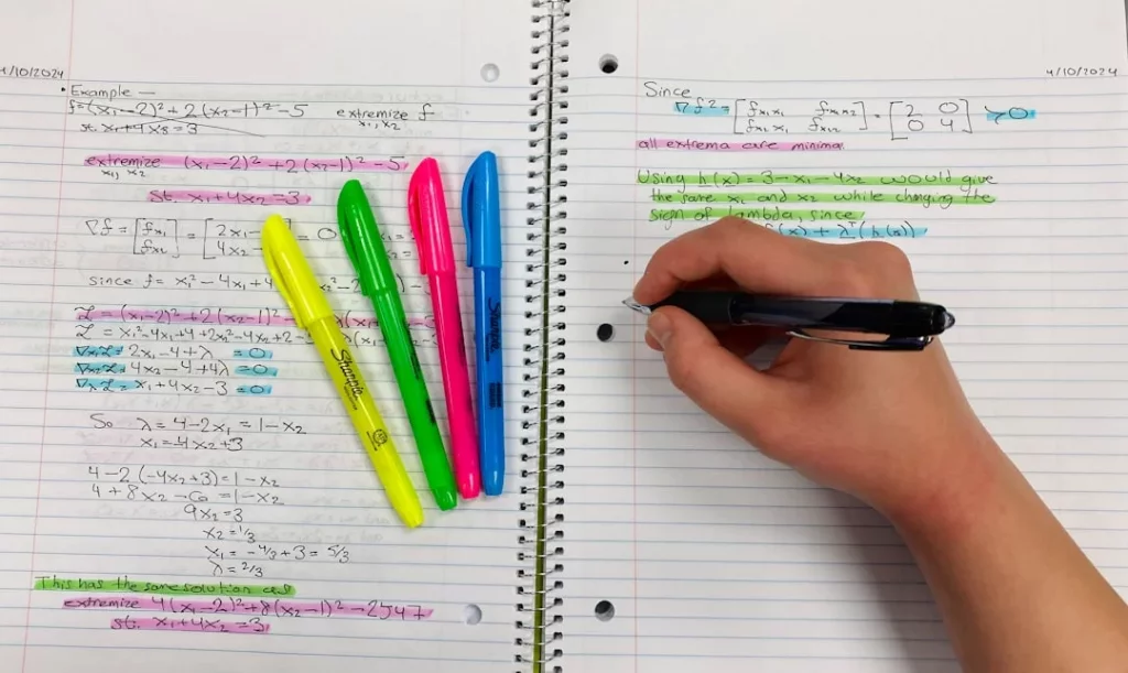 Student using colored pens in a notebook to apply the interleaving study method effectively