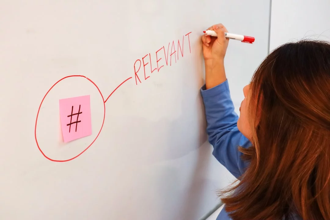 Woman outlining an interleaving study method schedule on a whiteboard with a marker