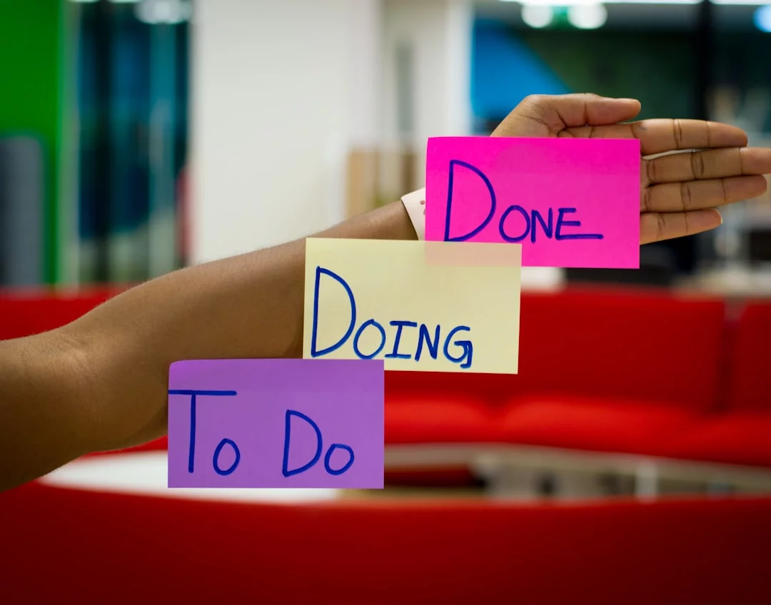 Intrinsic vs Extrinsic Motivation at Work: Improve Follow-Through Person holding purple and pink box illustrating intrinsic vs extrinsic motivation at work in workplace examples