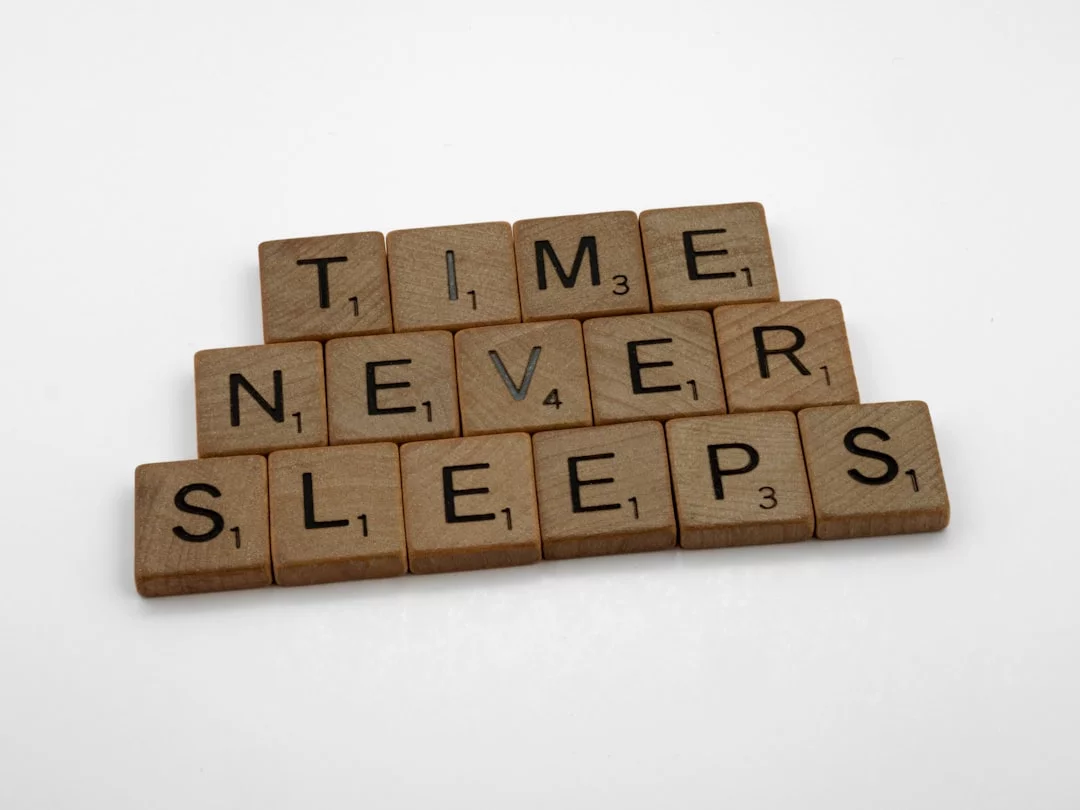 Scrabble tiles spelling time never sleeps illustrate revenge bedtime procrastination harming sleep and focus