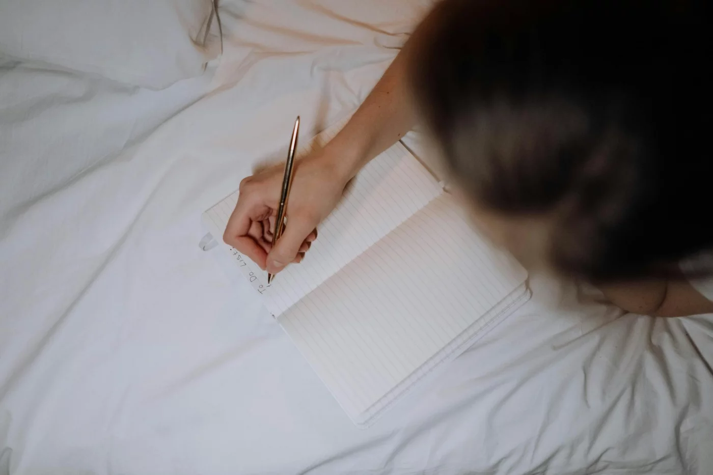 Notebook to-do list on a bed with quick fixes and FAQs for revenge bedtime procrastination and ADHD