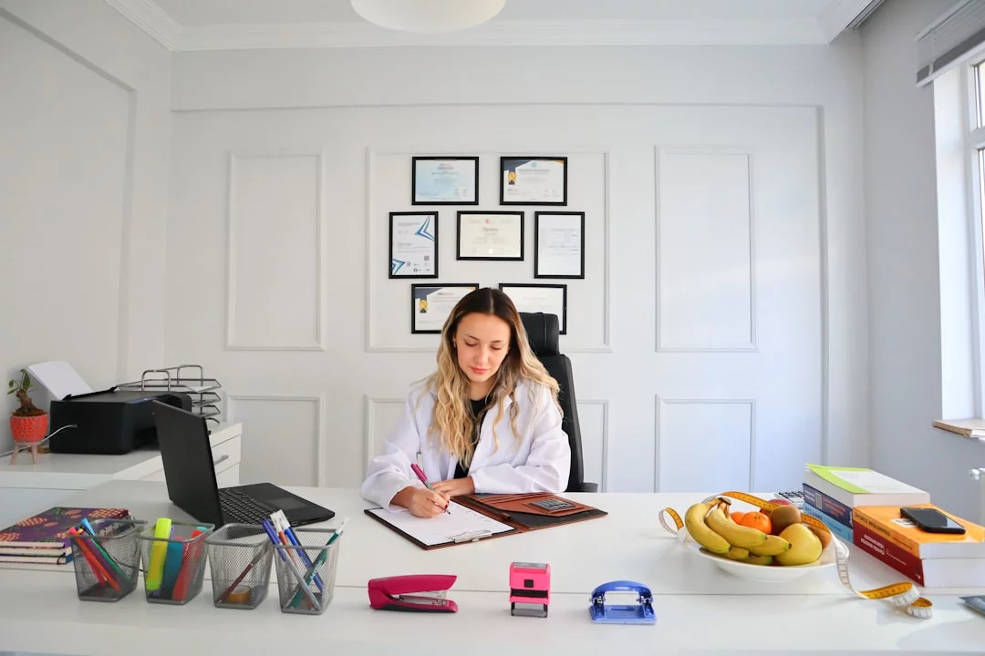 Woman at desk using laptop, setting personal boundaries at work with 7 proven steps and confidence