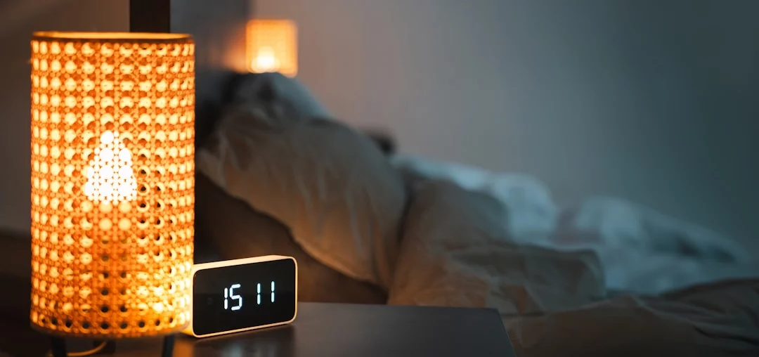 Sleep Restriction Therapy for Insomnia: 7 Smart Steps That Actually Make Sense Clock and lamp on a bedside table illustrating a sleep restriction therapy pdf schedule calculation