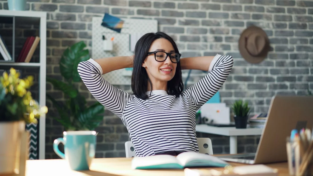 9 Evidence-Based Stress Reduction Techniques for Anxiety That Help Right Now Woman at desk practicing stress reduction techniques for anxiety during social anxiety and everyday overload