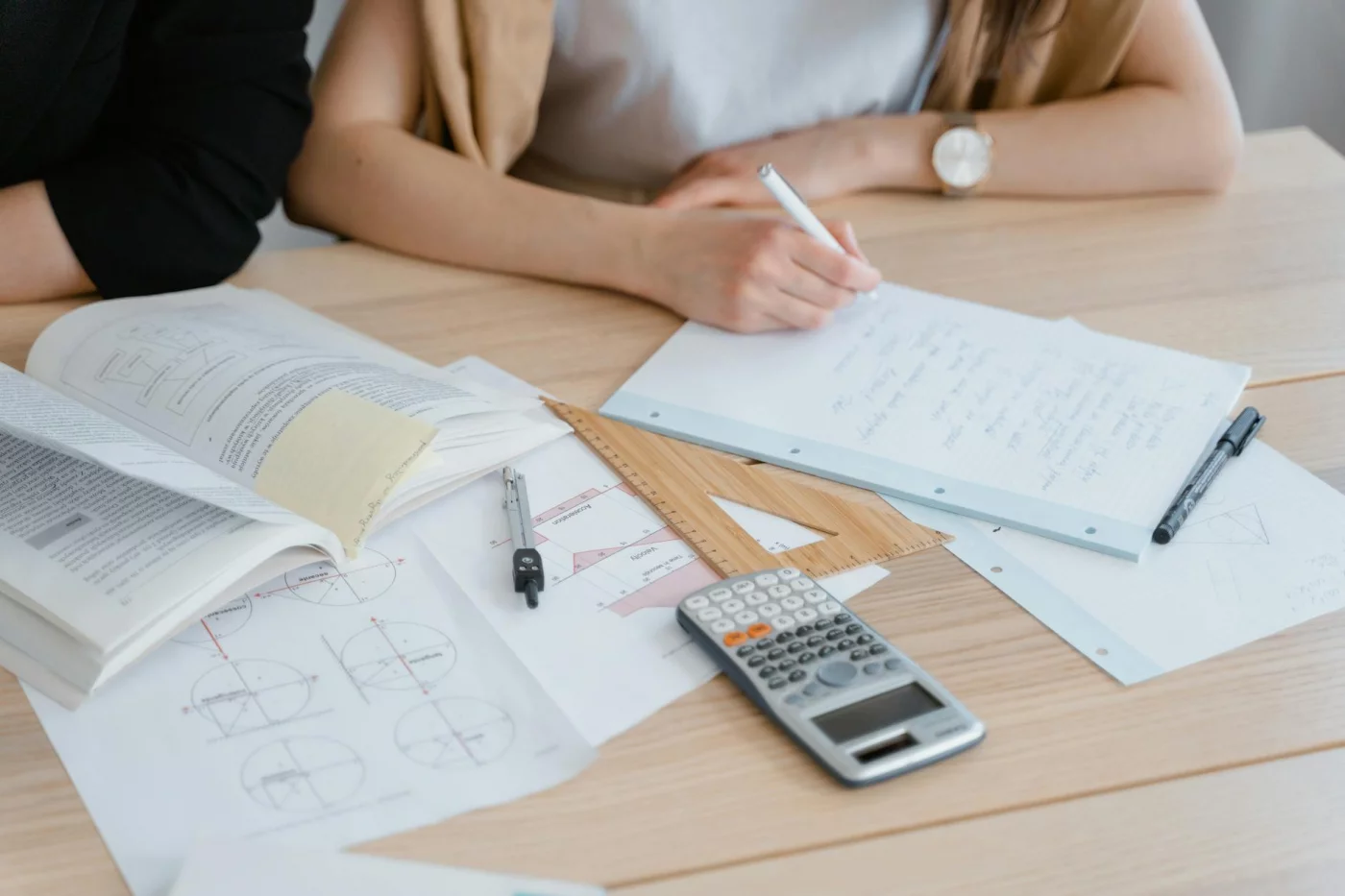 Ultradian Rhythms for Studying: 7 Smart Ways to Use 90-Minute Blocks Student writing notes with books and calculator, illustrating the ultradian cycle for studying