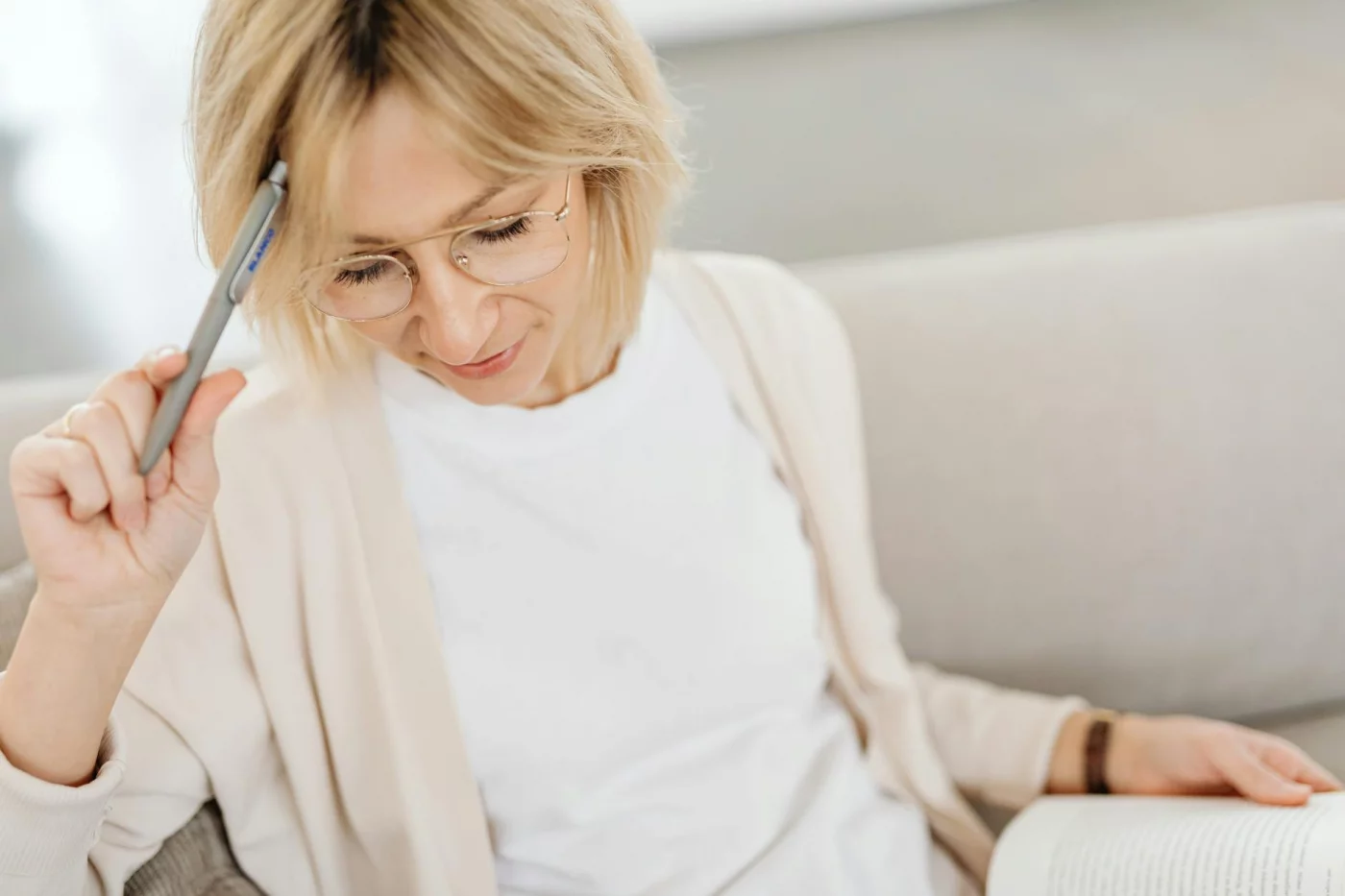What Are Early Signs of Cognitive Decline? 7 Warning Signs to Know Woman reviewing notes and a book to track what are early signs of cognitive decline before a doctor visit