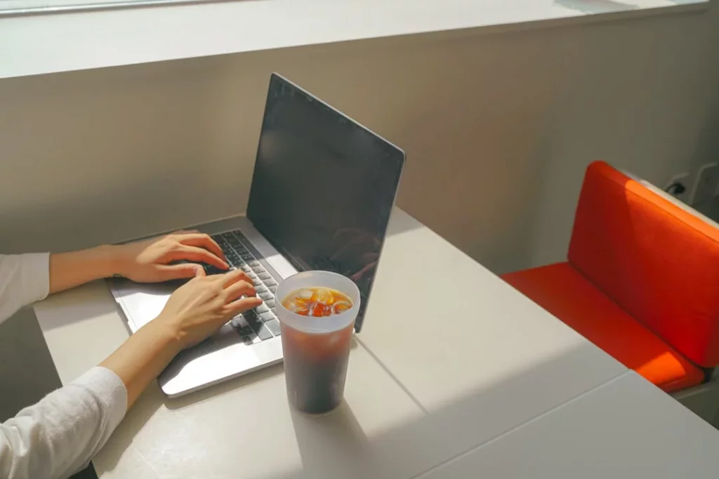 Woman researching what is best brain foods on a laptop at a table