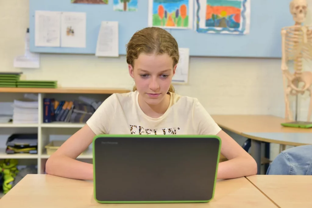 Does the Pomodoro Technique Help ADHD? What Actually Works Student focused on a laptop in class, exploring what is the Pomodoro method for ADHD support