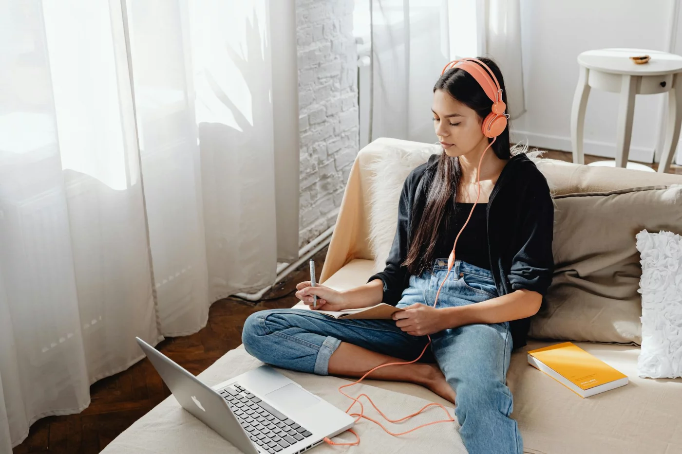 What Is Immersion Language Learning and How Can You Use It at Home? Student with headphones using a laptop at home to explore what is immersion language learning online