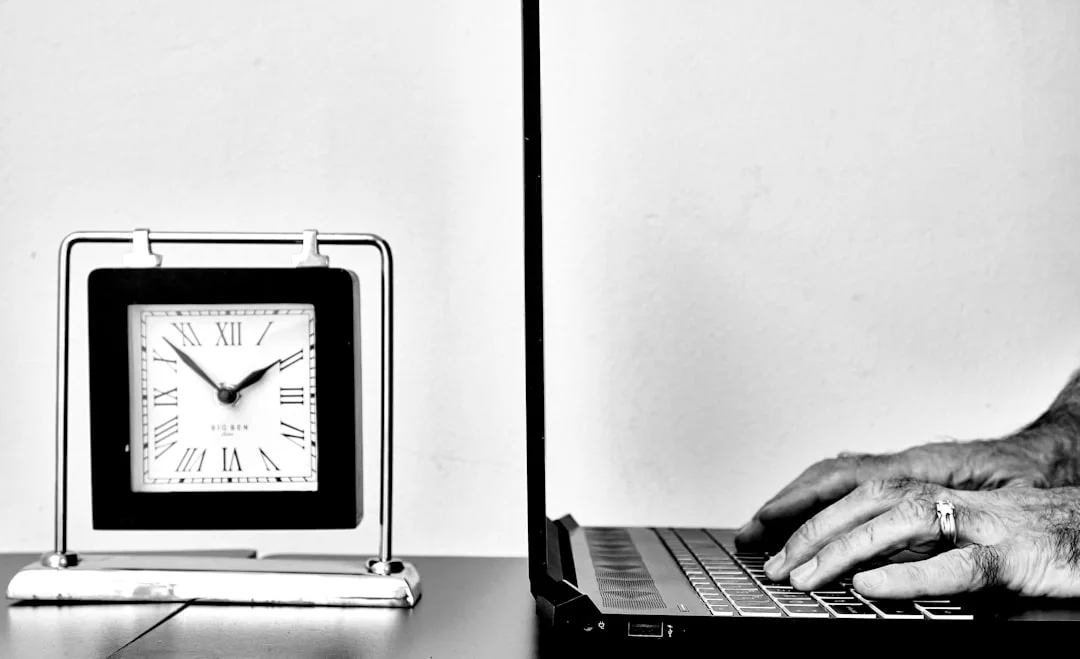 Does the Pomodoro Technique Help ADHD? What Actually Works what is the Pomodoro Technique? Person typing on a laptop beside a clock, illustrating ADHD-friendly focus timing