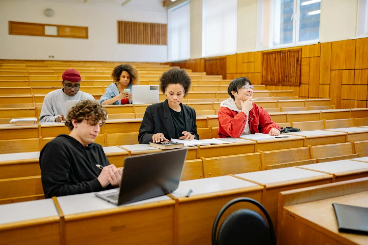 Does the Pomodoro Technique Help ADHD? What Actually Works Students using laptops and books in class to learn what is ADHD-friendly Pomodoro for study and focus
