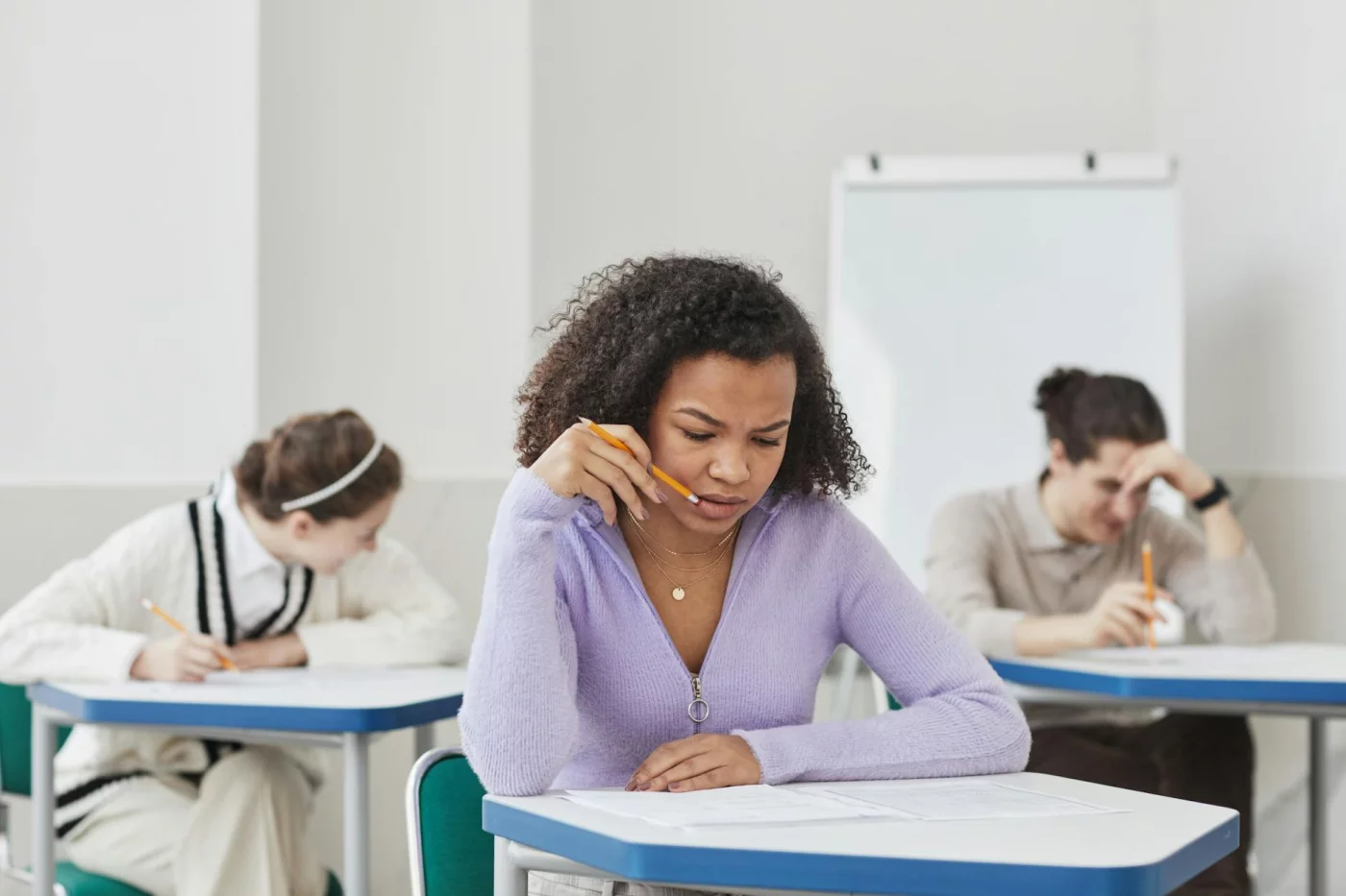 How to Calm Test Anxiety Before an Exam Focused students taking an exam in class, illustrating test anxiety and what is the 3 3 3 rule for anxiety