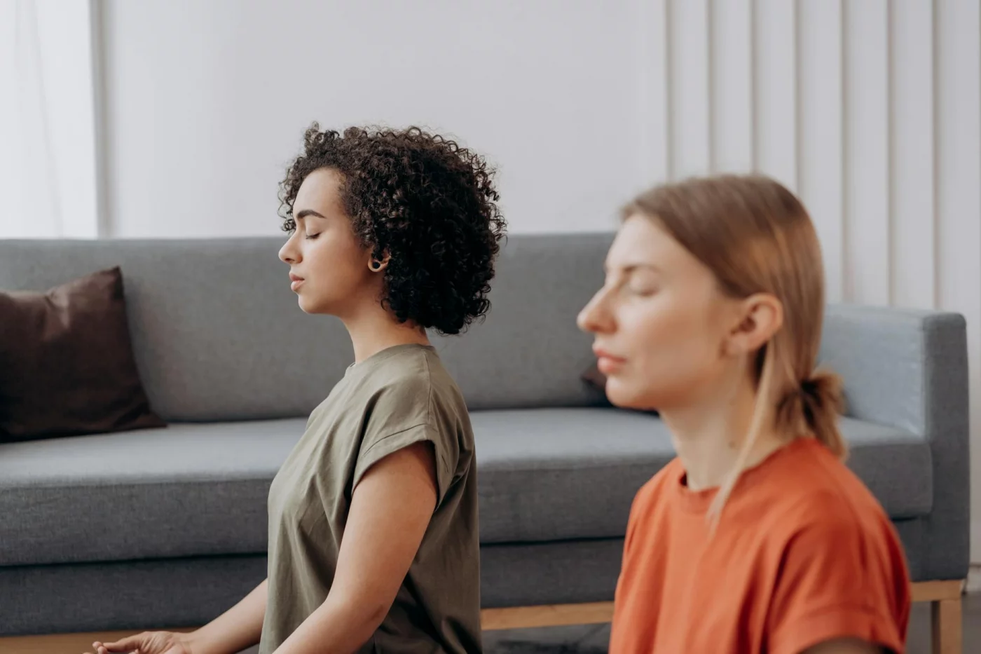 Two women using a 2 minute meditation script in a calm indoor space for fast stress relief