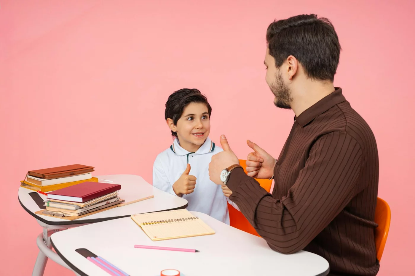 Teacher and student share a thumbs up in class, showing how ai homework help for students can boost learning