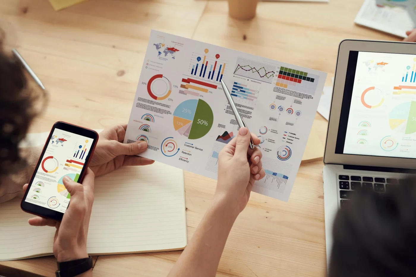 What AI Slop in the Workplace Really Means for Productivity Team members review charts in a meeting, illustrating ai slop in the workplace as productivity gains begin to stall