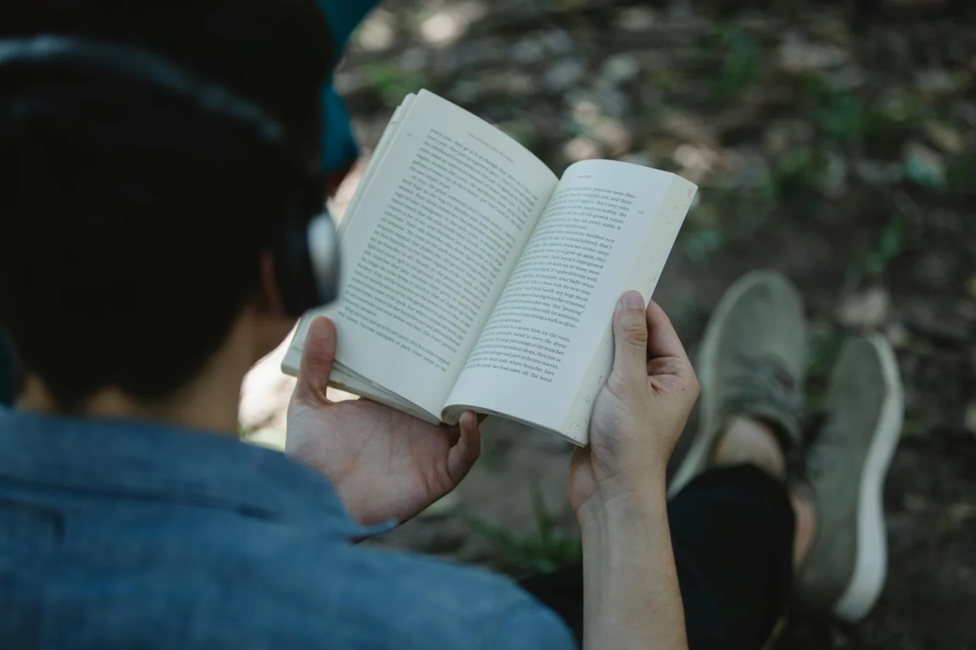 Binaural Beats vs Lo-fi vs Silence for Focus Student in a park reading with headphones, comparing binaural beats for studying by task and personal focus style