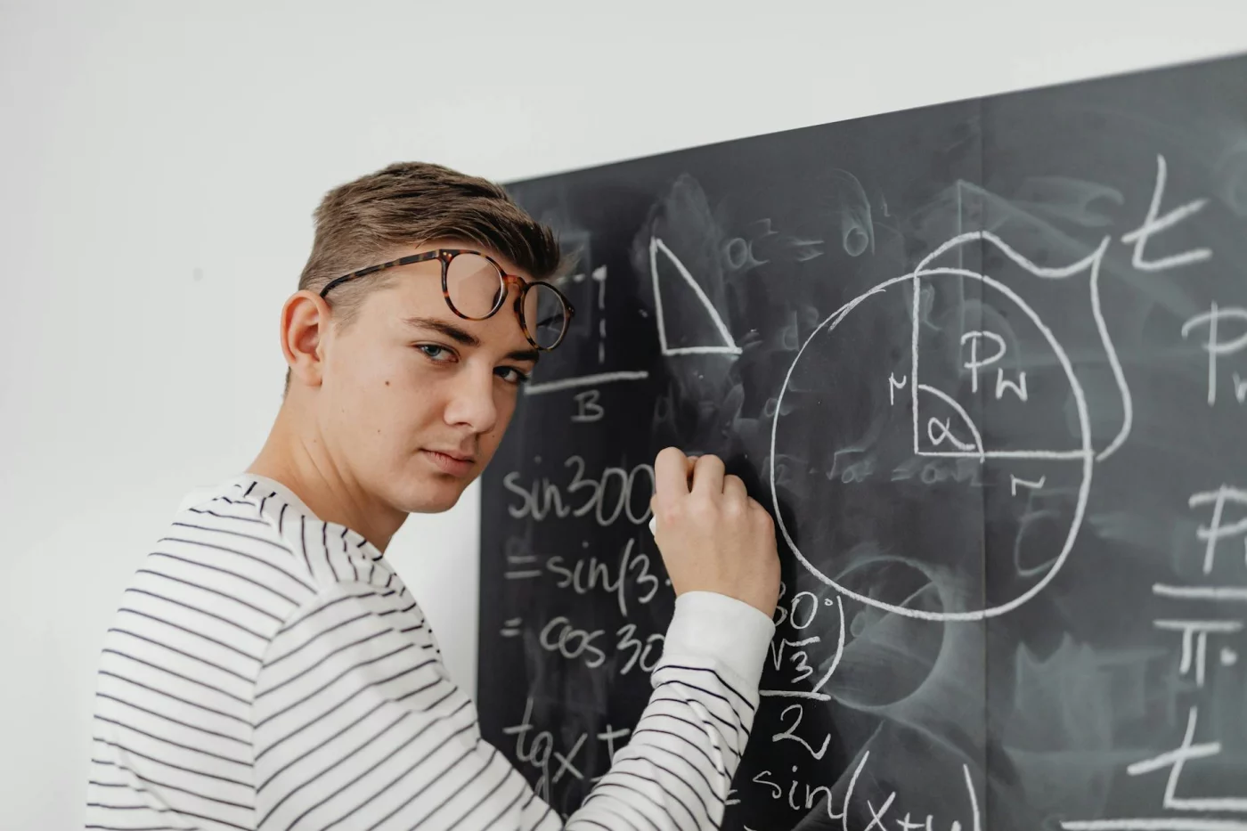 Teenager solving geometry on a blackboard, illustrating blurting method vs active recall study mistakes