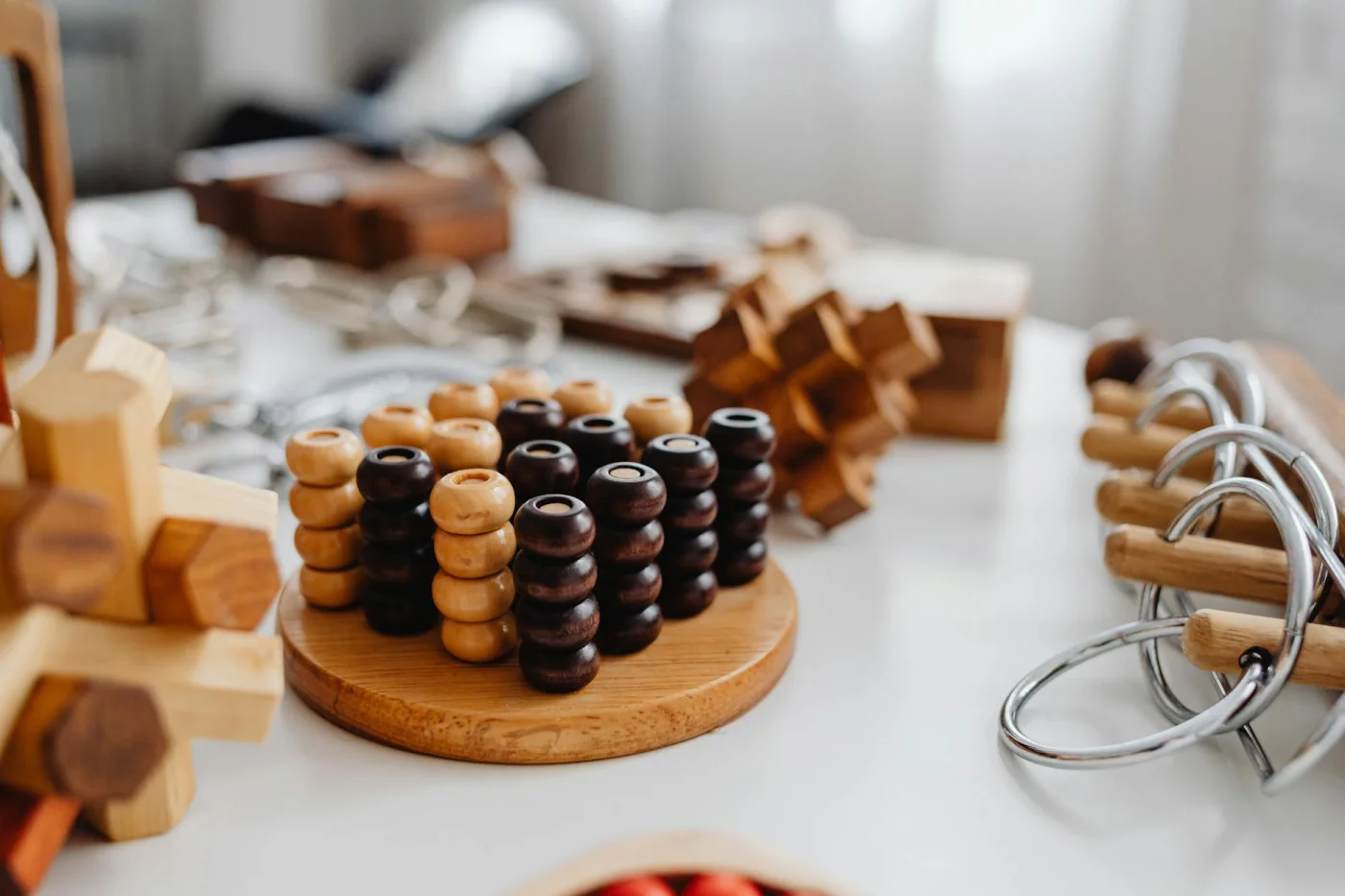 Do Brain Exercises to Improve Concentration Really Help Daily Focus? Wooden brain teaser puzzles on a table as brain exercises to improve concentration at home